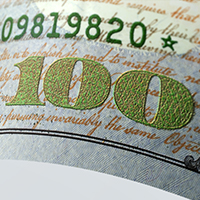 A close up of the two-tone ink on the 2013 $100 bill.