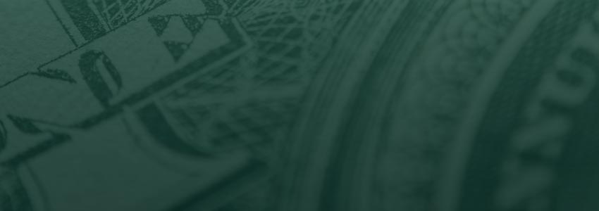 Tight crop of a one dollar bill, showing the "ONE" text and the fine patterns of the design.
