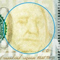 Close up of watermark of Benjamin Franklin's face on the 2013 $100 bill.